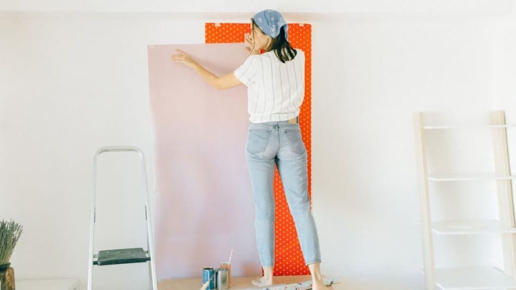 Renter-friendly upgrades in progress: applying peel-and-stick wallpaper to a rental wall