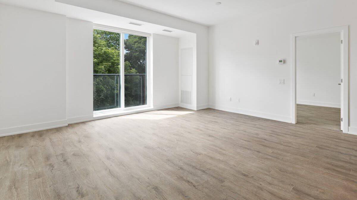 empty room with a sliding glass door and pale wood floor