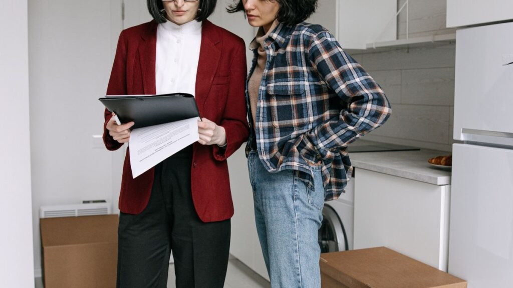 a renter and a leasing agent going through lease clauses before signing
